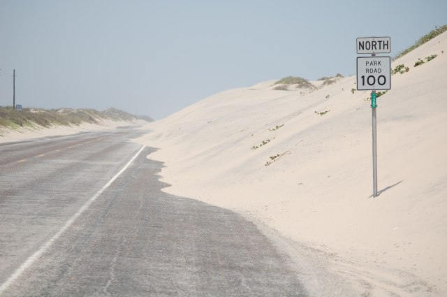 Sand dunes reclaiming road